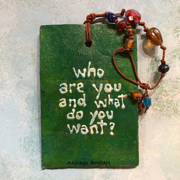 "Who are you and what do you want?” watering can and britches ornament by artist Andrea Bogdan