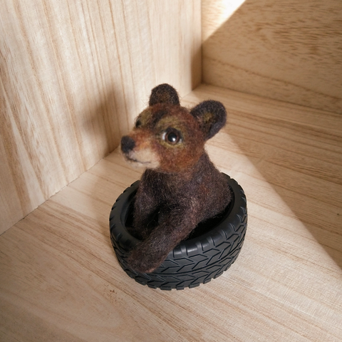 BEAR CUB WITH TIRE by artist Julie Bossinger
